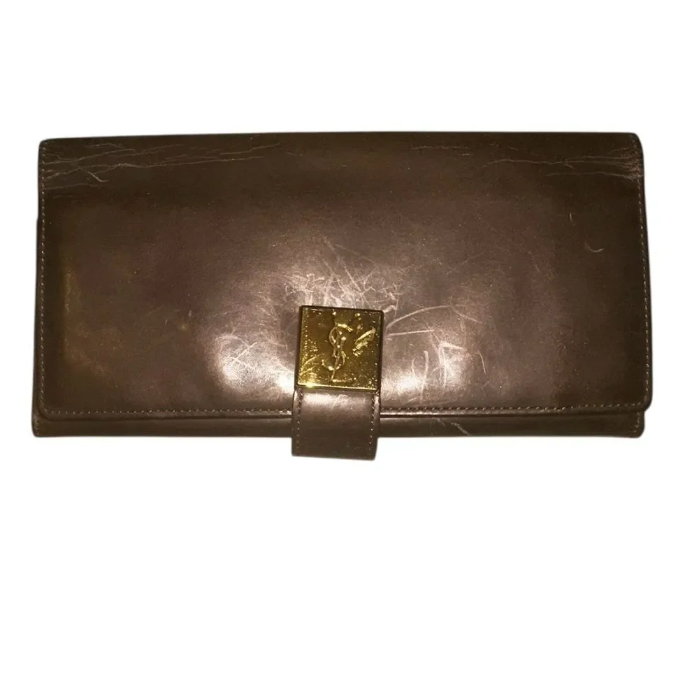 Yves Saint Laurent Tan Leather Wallet with Gold Clasp with marks and scratches.